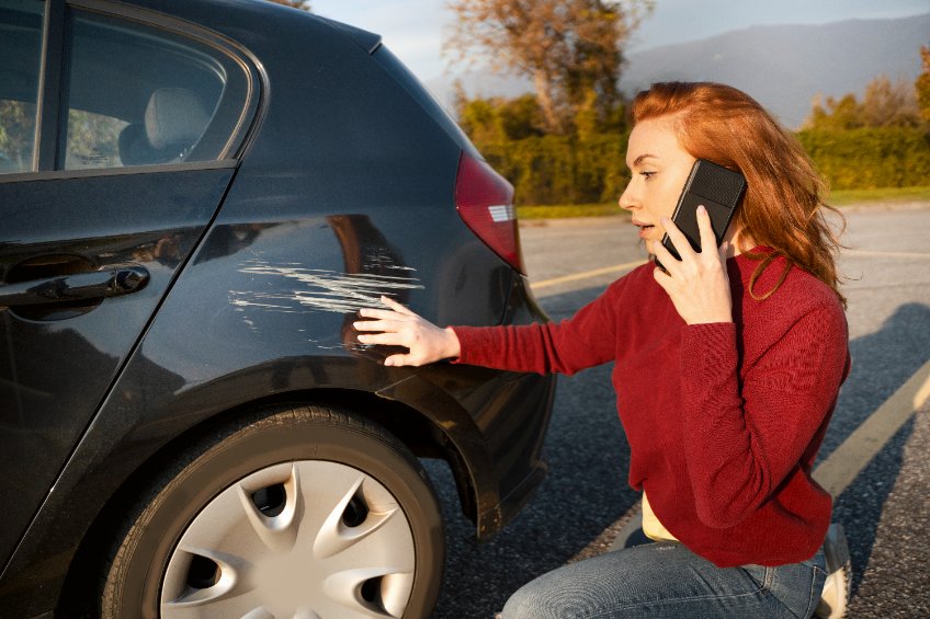 Woman inspecting damage