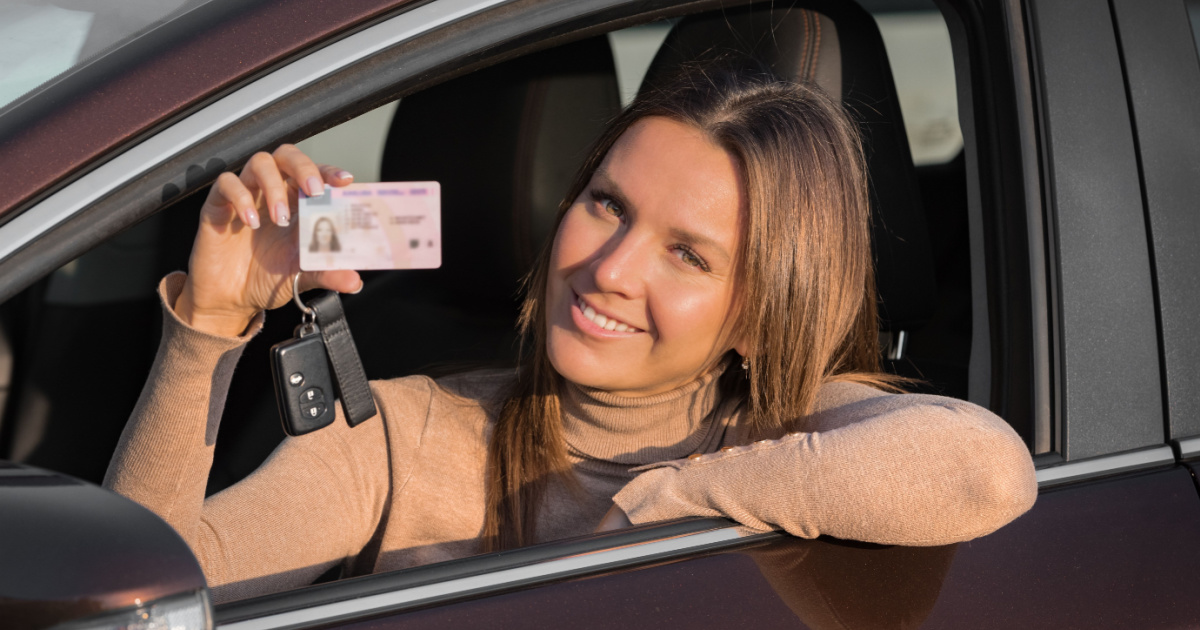 smiling woman showing her license