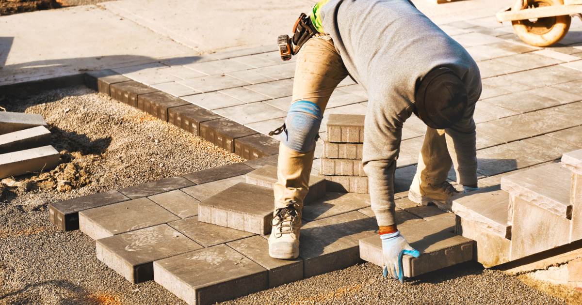 Landscaper installing pavers - covered by Missouri landscaping insurance