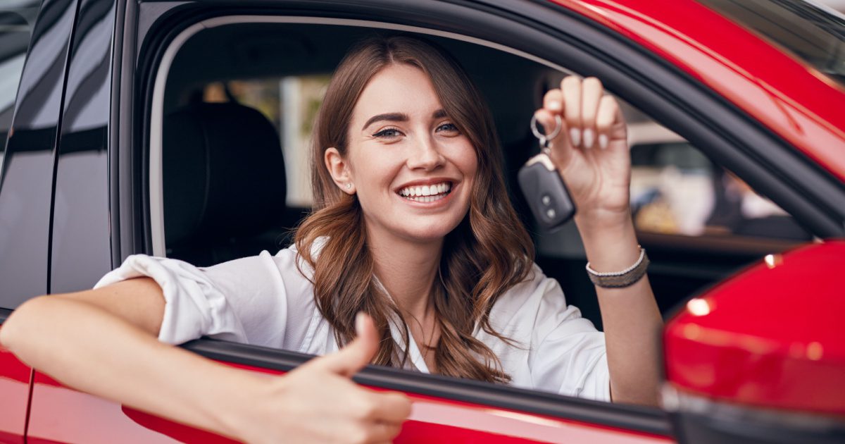 Woman showing her new car after getting Illinois car insurance