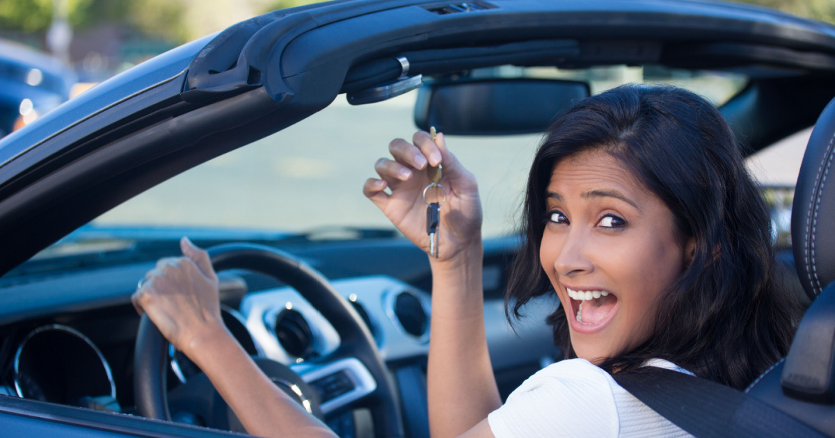 Young woman enjoying her new car after purchasing Missouri car insurance