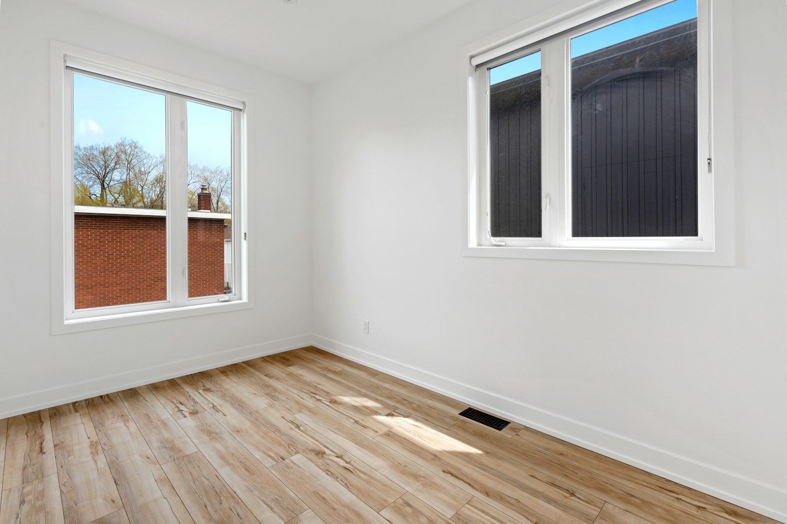 a room with windows and a wood floor vacant property