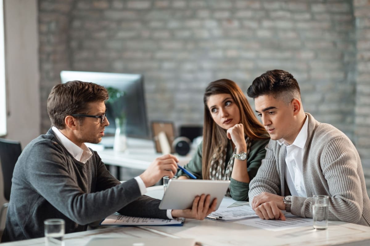 Young couple talking to an insurance agent