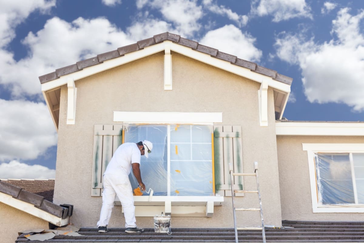House painter painting a house