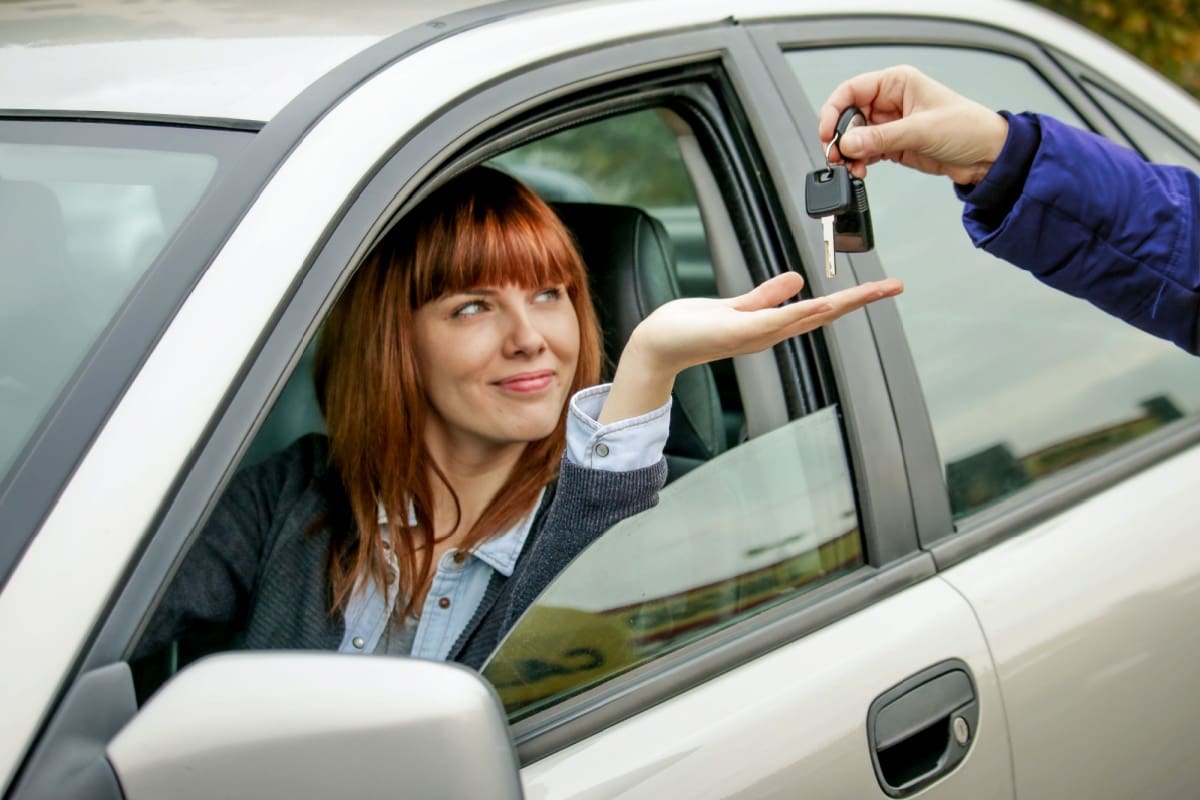 Handing over car keys to a friend.