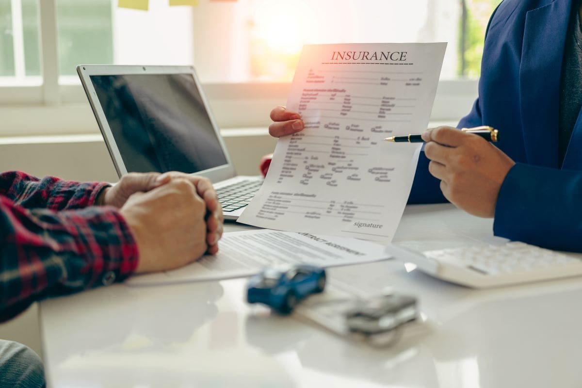 Insurance agent explaining the auto policy to a customer