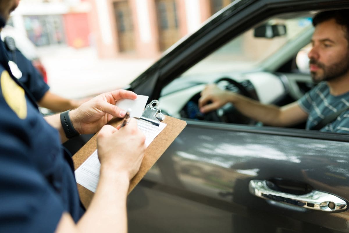 Driver receiving a speeding ticket from a police officer